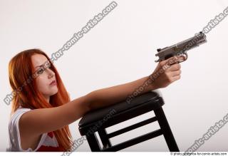 24 2018 01 TINA KNEELING POSE WITH GUNS